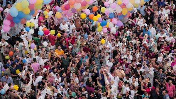 Egyptian Muslims release balloons at the end of prayers on the first day of Eid al-Fitr holiday that marks the end of the holy fasting month of Ramadan on June 25, 2017, in Cairo. (Samer Abdullah/AFP)