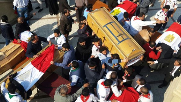 Egyptian clergymen and officials carry the coffins of the victims of a church bombing in Cairo, on December 12, 2016. (AFP/Khaled Desouki)
