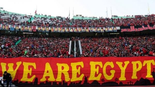 Members of the Ahlawy Ultras hold up a banner during a game (AFP/ File Photo)