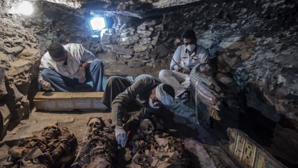 A picture taken on September 9, 2017 shows Egyptian labourers and archaeologists unearthing mummies at a newly-uncovered ancient tomb for a goldsmith. (Khaled Desouki/AFP)