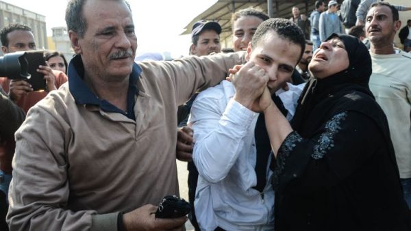 An Egyptian man embraces his parents following his release from prison in Cairo on March 14, 2017, along with 202 other prisoners who received a presidential pardon. (AFP/Aly Fahim)