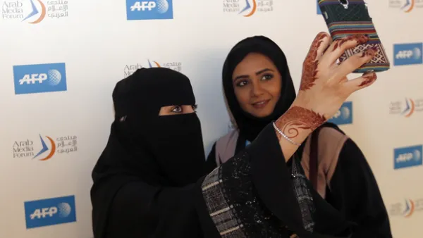 Emirati women take a selfie during the opening festivities for the Arab Media Forum in Dubai. (AFP/File)