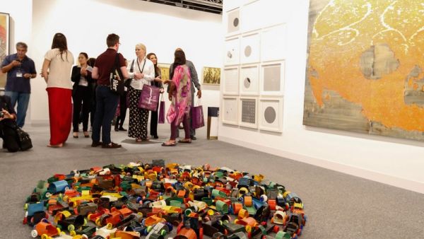 Visitors at Abu Dhabi Art 2016; a floor piece by Hussain Sharif (foreground). (Gulf News)