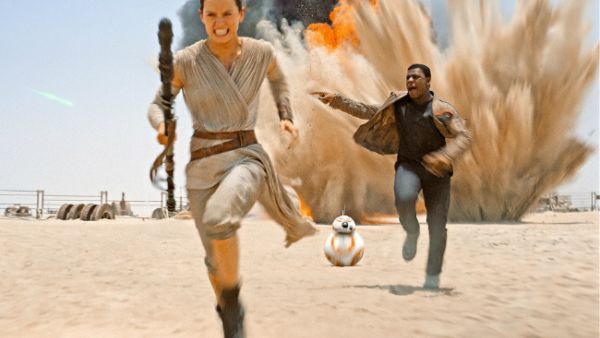 Daisy Ridley and John Boyega flee spoilers. (Walt Disney)