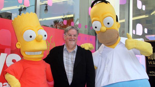 Matt Groening with Homer and Bart, notably not murdering them. (s_bukley / Shutterstock.com)