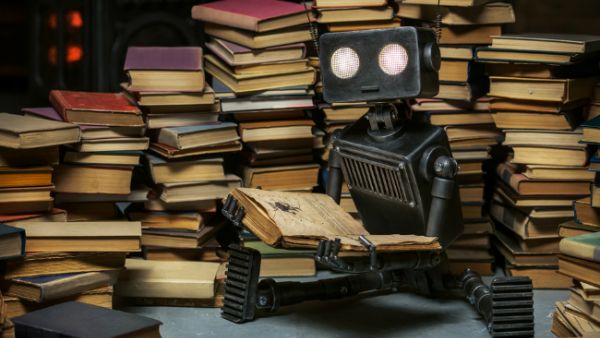 A robot reads at home. (Vasilyev Alexandr / Shutterstock.com)