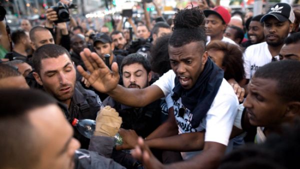 Ethiopian-Israelis and Israeli police scuffle in Tel Aviv last year (AFP/File)