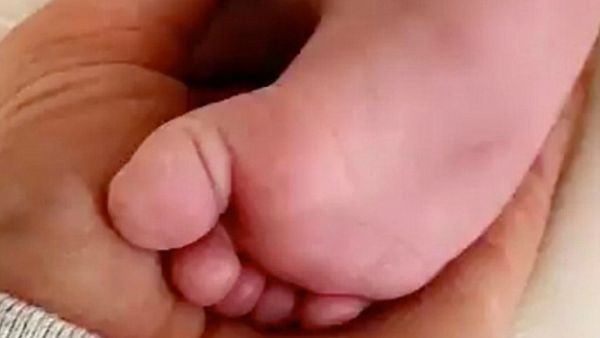 Too cute: Kylie Jenner, 20, doted on her baby daughter Stormi in a Snapchat clip posted Sunday, in which she played with her infant daughter's feet (Source: Kylie Jenner - Snapchat)