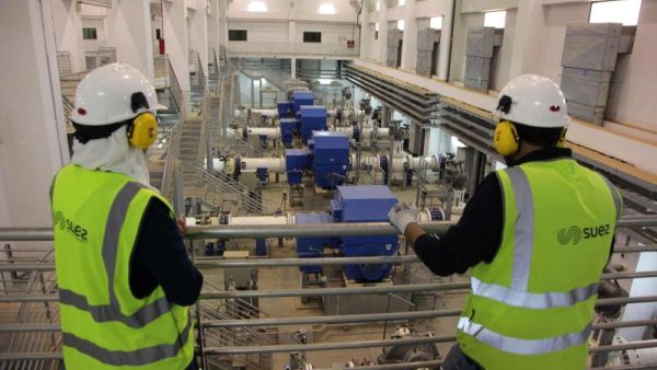 Workers look at the pumping station of the Disi water Project in Amman. (AFP)