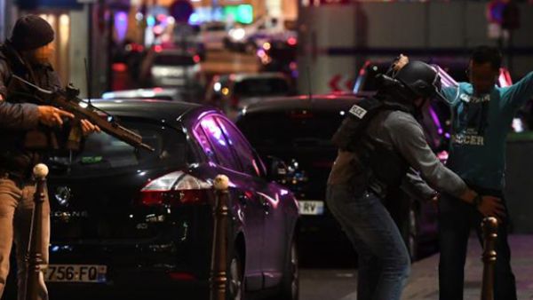 Police officers frisk a man on the Champs Elysees in Paris after the deadly shooting. (AFP)