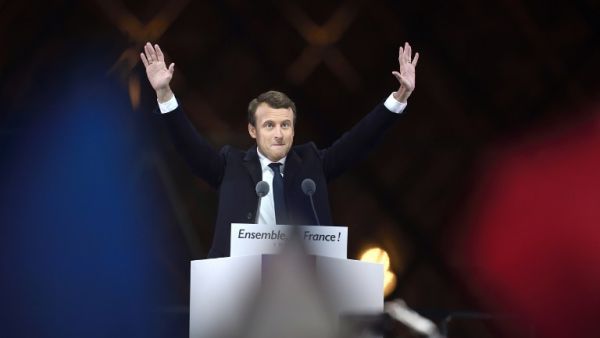 French president-elect Emmanuel Macron greets supporters as he arrives to deliver a speech in front of the Pyramid at the Louvre Museum in Paris on May 7, 2017, after the second round of the French presidential election. (AFP/Eric Feferberg)
