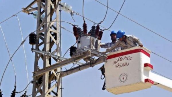 A file photo of workers conducting maintenance on a Gaza power line. (AFP/File)