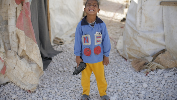 A boy plays with his toy gun at a Syrian refugee camp in Lebanon's Bekaa Valley.  (AFP/Matthieu Alexandre)