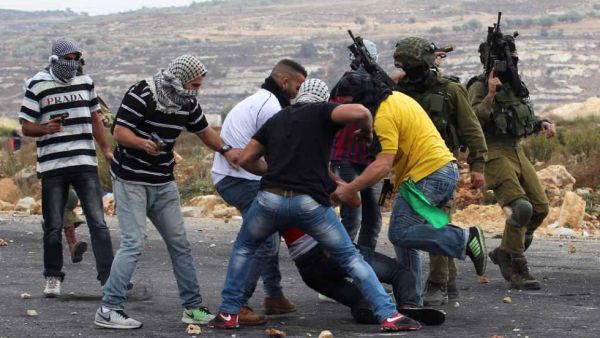 Members of Israeli security forces disguised as Palestinians fire bullets into a demonstration outside Ramallah on October 7, 2015.  (AFP/Abbas Momani)