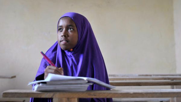 A student wearing a hijab takes notes in her exercise book (Image for illustrative purposes - Credit: AFP)