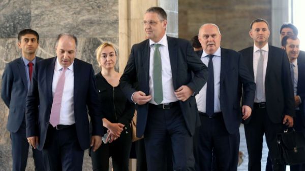 German Secretary of State for Foreign Affairs Markus Ederer (C) walks with Istanbul's deputy Mustafa Yeneroglu of Turkey's ruling Justice and Development Party (AKP) as they visit the damaged Turkish Grand National Assembly in Ankara, on August 8, 2016 following a failed military coup on July 15. (AFP/Adem Altan)