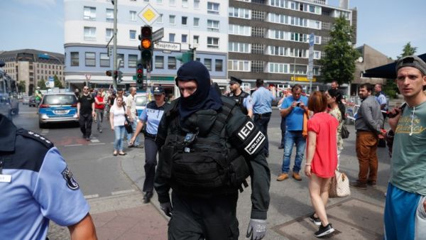 A policeman of a special unit wears protective clothing as he walks through Berlin's Schoeneberg district, where a man was arrested after a suspicious car was found shortly before an event to celebrate the 100th birthday of former US President John F Kennedy, on May 29, 2017. (AFP/Odd Andersen)