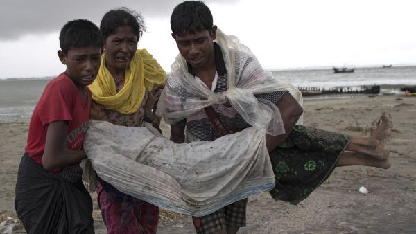Rohingya Muslim refugees walk on the Bangladeshi shoreline of the Naf river (AFP/File Photo)	
