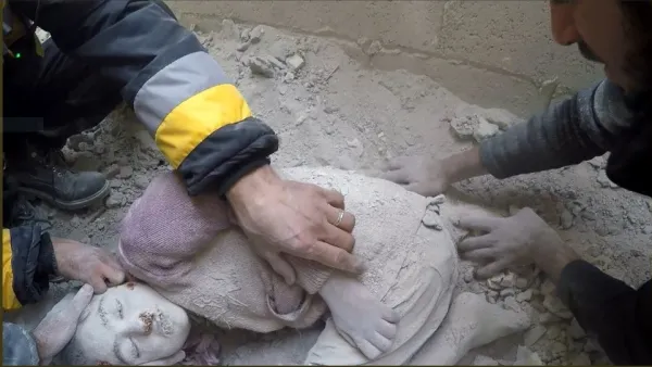 The body of a Syrian child is pulled out from the rubble following an airstrike in Eastern Ghouta, Syrian Civil Defense - Rif Dimushq