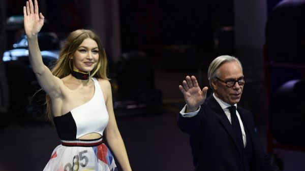 Gigi opened Sunday night’s show with a pair of blue and black leather racing leggings and a Hilfiger bandeau top, and closed in a long diaphanous layered maxi dress with racing logo prints. (Source: MIGUEL MEDINA - AFP)