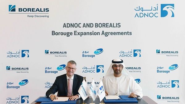 Dr. Sultan Al Jaber and Mark Garrett sign