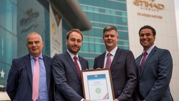 Michael Herero, IATA Area Manager Gulf, second left, presenting the certificate to Etihad Airways management, from left, Umberto Nicolardi, Head of E-Commerce; Justin Warby, Vice President Digital Transformation and Innovation; and Leslie Varghese, Senior Manager Distribution.