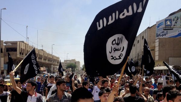 ISIS supporters wave their infamous black flag in a demonstration. (AFP/File)