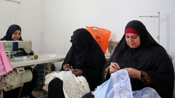 Palestinian women embroider at a workshop in Jerash refugee camp, northern Jordan (AFP Photo)