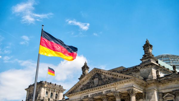 German flags waving in the wind at famous Reichstag building, seat of the German Parliament (Shutterstock/File Photo)
