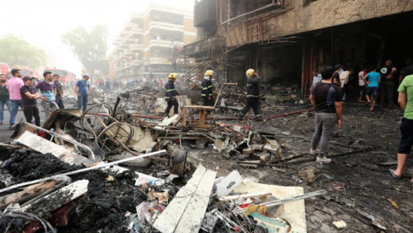 Emergency responders and civilians react to the scene of a car bomb in Baghdad's Karrada district on July 3, 2016. (AFP/File)