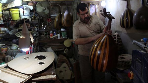 Musician and artisan Ali Mohammed Abdali makes an oud at his workshop on Baghdad's Rashid Street. (AFP/File)