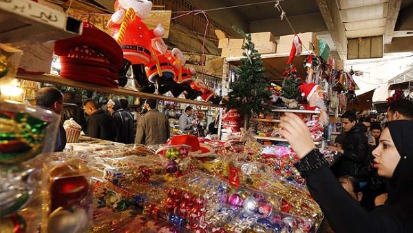 Iraqis shop for Christmas and New Year decorations and gifts at central Baghdad's Shorja market on December 20. (AFP/File)