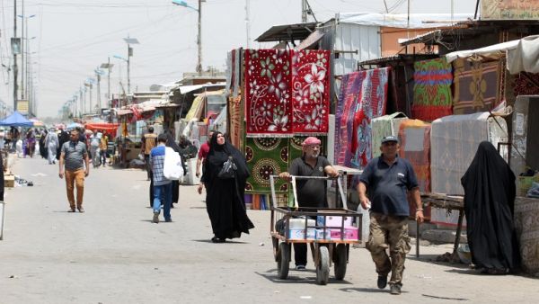 Iraqi walk past stalls at Oraiba market on May 12, 2016, a day after it was struck by a car bomb attack in the frequently targeted Sadr City area of northern Baghdad. (AFP/Ahmad al-Rubaye)