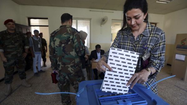 A member of the Kurdish security forces casts her ballot at a polling station for parliamentary election in Arbil, the capital of the Kurdish autonomous region in northern Iraq, on September 28, 2018, as Kurdish armed forces vote ahead of the general public. (SAFIN HAMED / AFP)