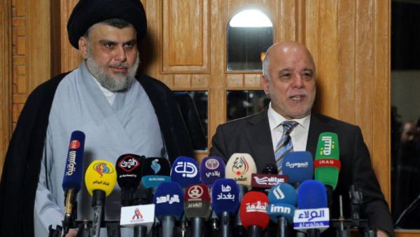 Iraqi Prime Minister Haider al-Abadi (R) and Shiite cleric leader Moqtada al-Sadr have reached an accord with 14 other Iraqi political grouping to form the biggest bloc in parliament. (AFP/ Haidar HAMDANI)