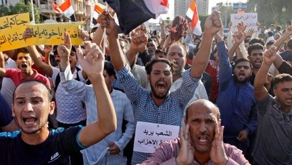 Iraqis shout slogans during a protest in Najaf.  (AFP/ File Photo)