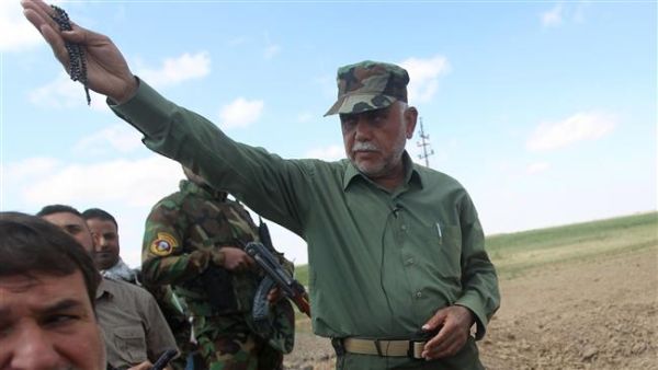 Iraqi commander of the Badr Organization, Hadi al-Ameri (R), standing in the Al-Alam area, north of Baghdad. (AFP/ Photo)