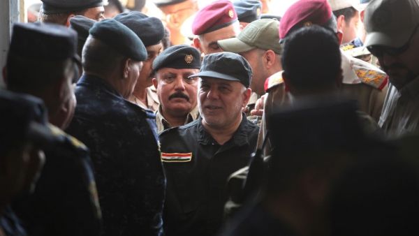 Iraqi Prime Minister Haider al-Abadi (C) arrives in the al-Tayaran neighborhood of Mosul on July 9, 2017 to meet with military commanders after the government's announcement of the "liberation" of the embattled city. (Ahmad Al-Rubaye/AFP)