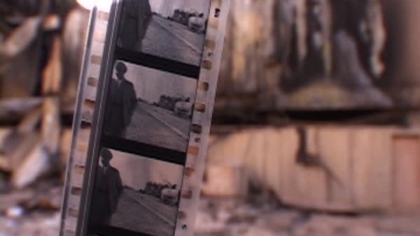Strip of black and white movie film, out of focus bombed Baghdad Cinema Studios. (Shutterstock)