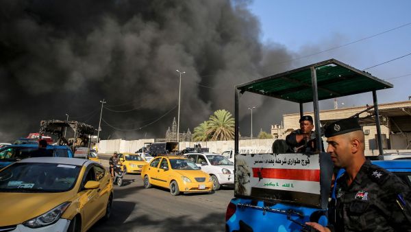 Members of the Iraqi federal police outside a ballot warehouse in Baghdad caught on fire. (AFP/ File)