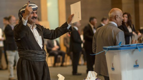 An officials of Kurdistan Regional Government shows his ink-stained finger after casting his vote. (Ahmed Deeb / AFP)