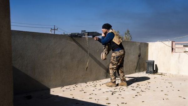An Iraqi army soldier fires his machine gun at Islamic State positions in Mosul's al-Sahiroun neighborhood on January 12, 2017. (AFP/Dimitar Dolkoff)