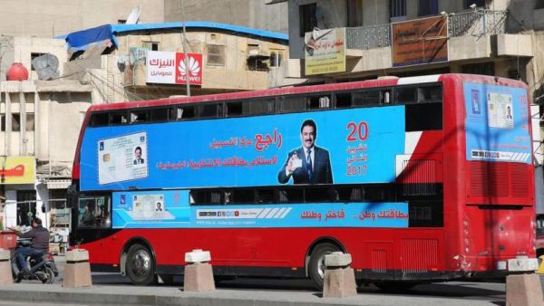 A bus displays poster advising people to check their voting information ahead of Iraq's parliamentary elections. (AFP/ File Photo)