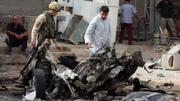 Iraqi troops inspect scene of car bomb in Baghdad. (AFP/Ahmed al-Rubaye)