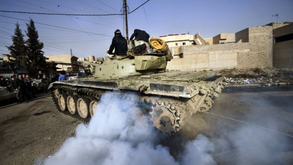 An Iraqi army T-72 tank heads to the frontline during a battle against the Daesh near the Fourth Bridge over the Tigris River connecting eastern and western Mosul on January 10, 2017. (AFP/Dimitar Dilkoff)
