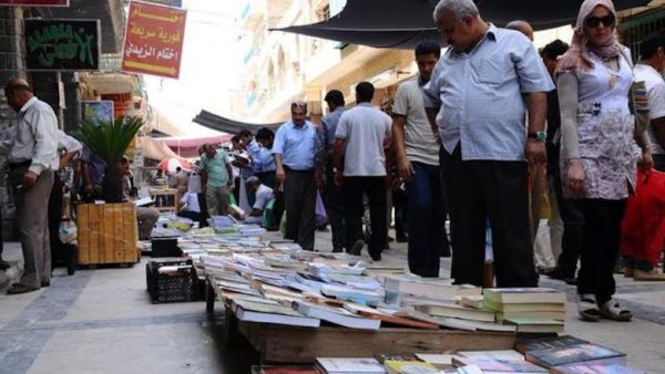 Pedestrians browse titles on al-Mutanabbi Street, Baghdad's famed cultural hub. (AFP/ File)