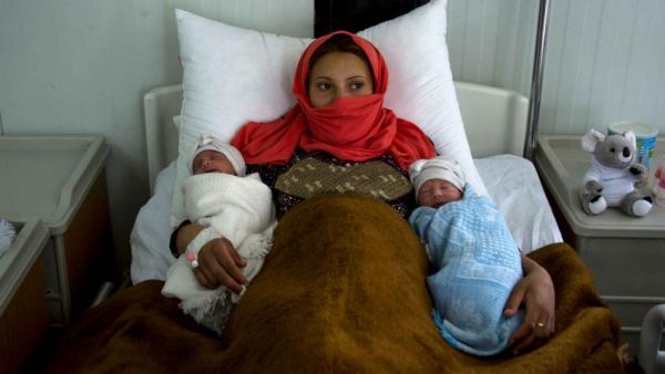 A mother of twins at a refugee camp near Mosul (AFP)