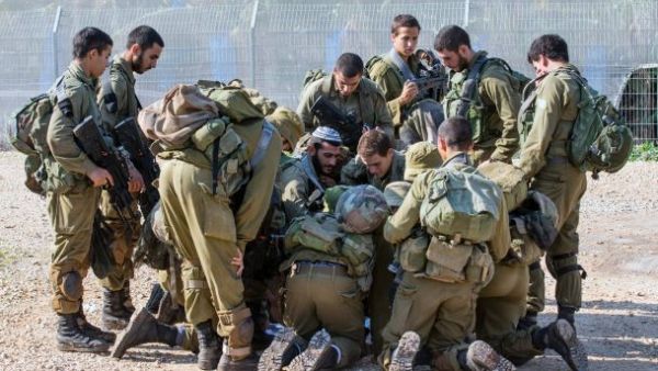 Israeli soldiers check a map as they patrol the northern Israeli-Lebanon border. (AFP/File)