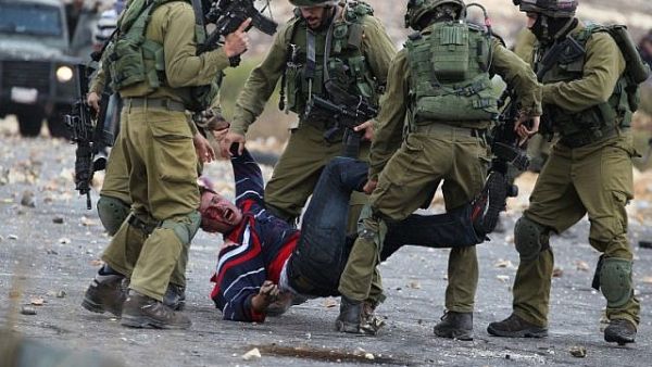 Israeli soldiers detain a Palestinian stone thrower near Beit El, on outskirts of the West Bank city of Ramallah. (AFP/ File Photo)