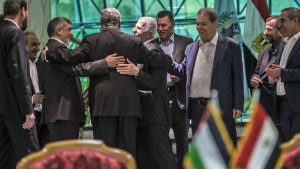 Khaled Fawzi (3rd-L) head of the Egyptian Intelligence services, shares a laugh with Hamas leader Izzat al-Rishq (2nd-L) and Fatah's Azzam al-Ahmad (C) following the signing of a reconciliation deal in Cairo on October 12, 2017 (Khaled Desouki/AFP)